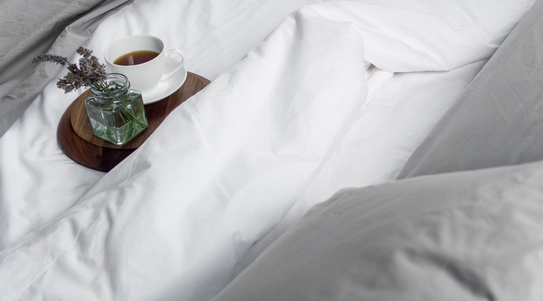 Breakfast in bed in cotton sheets